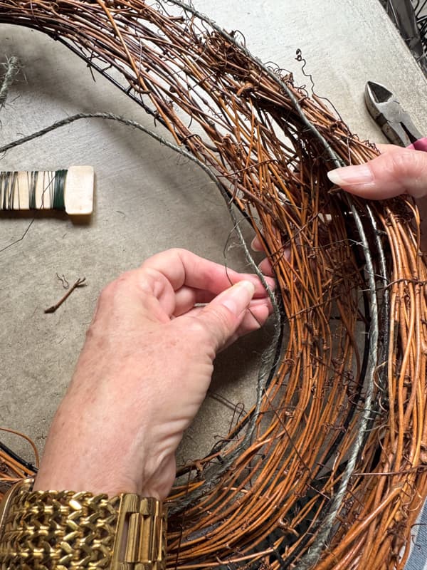 Adding wrapped twine wire to the oval wreath