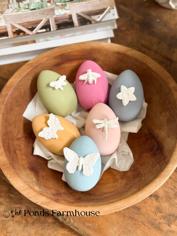 Bowl of DIY Easter Eggs with Bug Motifs made with hot glue