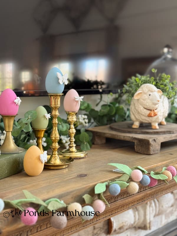 Easter Mantel with felt flower garland & DIY bug motif Easter eggs and lamb on riser