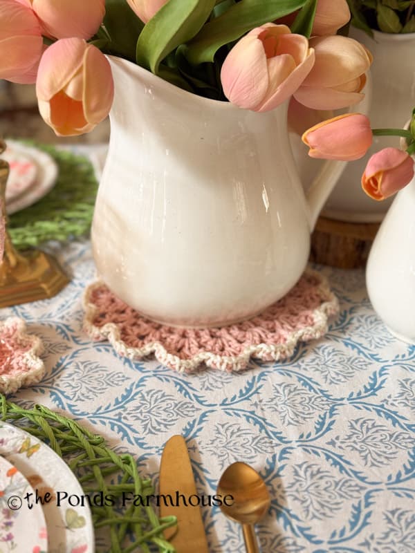 Pink & White Doily under ironstone pitcher with tulips on dining table
