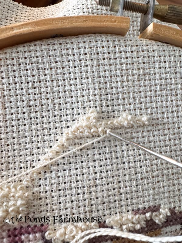 Insert in upper left corner and pull thread tight as you pull the needle and thread through the hole.  