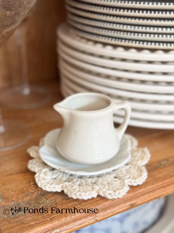 white doily with ironstone creamer