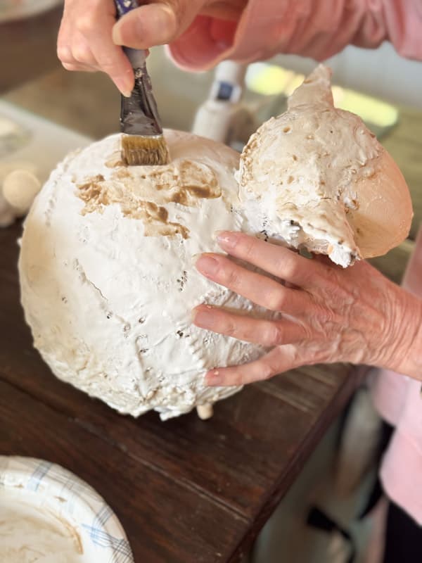 adding wax mixture to dry spackle on DIY Chunky Lambs