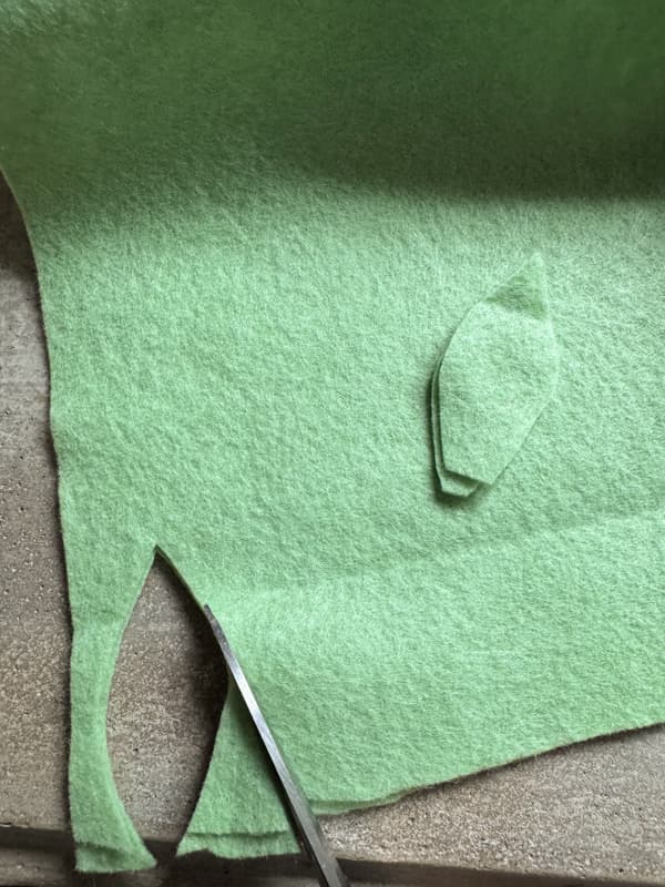Cut two leaves at once from green felt sheets