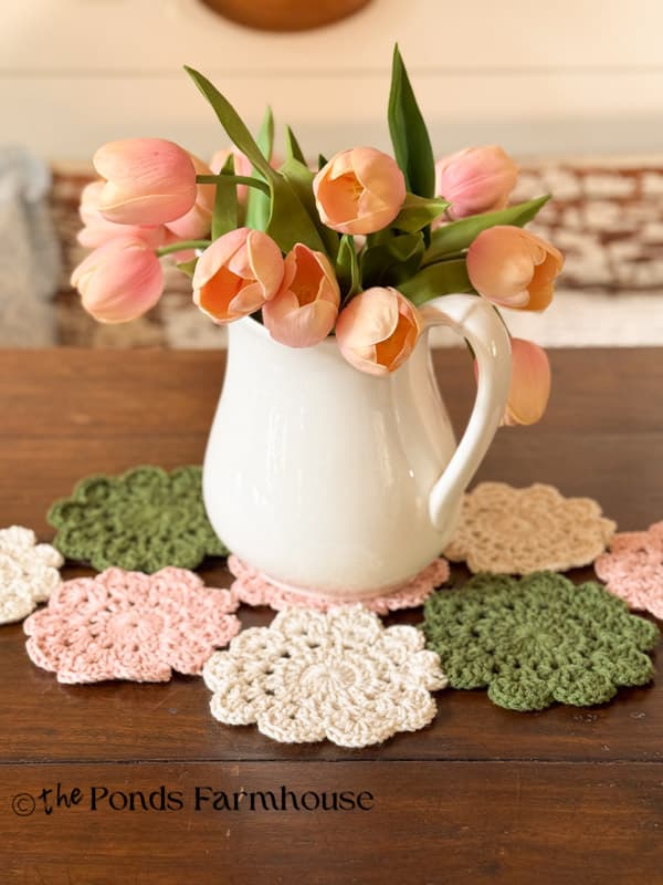 hand crocheted doily table runner on rustic farmhouse table with ironstone pitcher & pink tulips