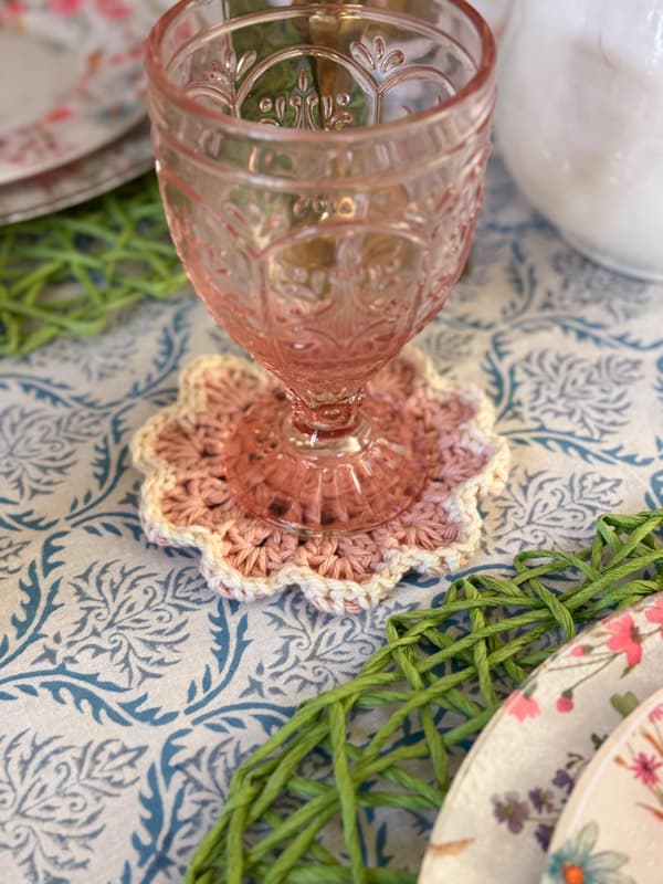 pink and white crochet doily coaster.