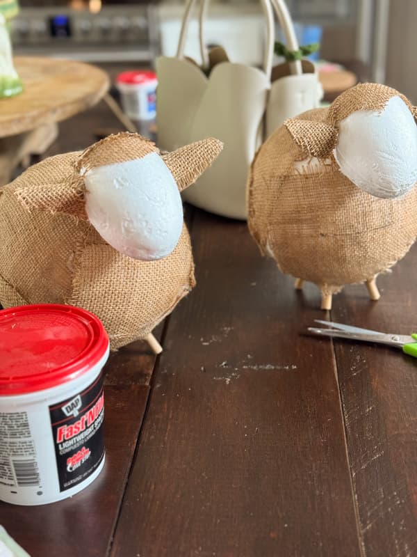 two DIY fat Lambs covered with burlap except for faces