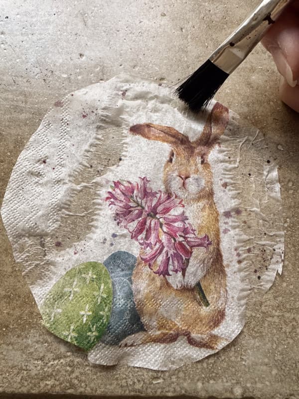 use damp paint brush to remove edges of the napkin for overlapping.