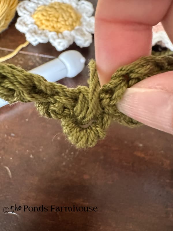wrap yarn over loop to secure loop