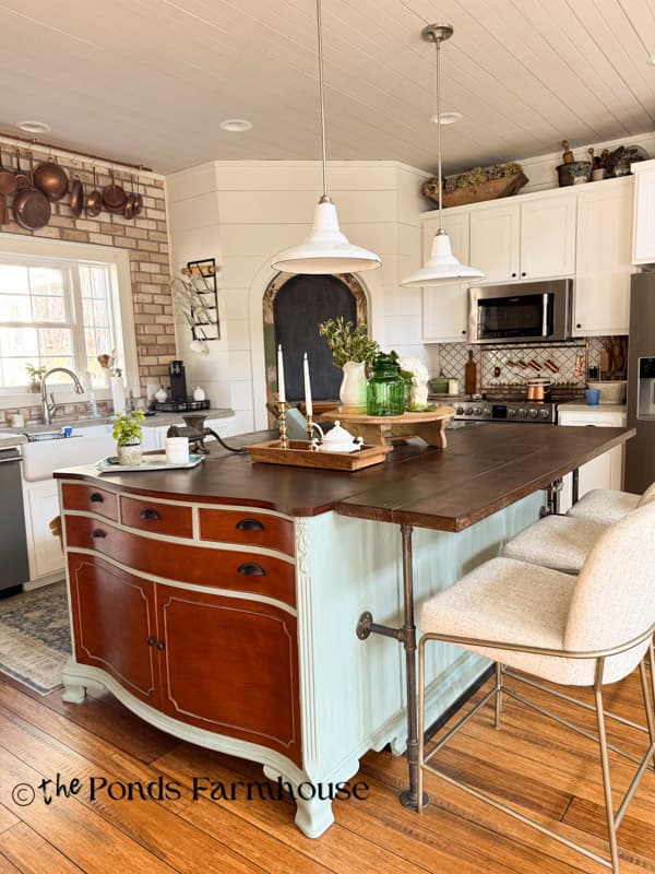 DIY Kitchen Island combining two pieces of furniture with natural wood top and industrial pipes