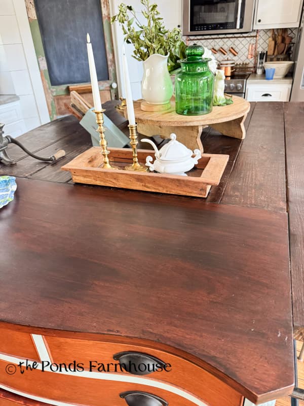 DIY kitchen island using furniture and joining the original cabinet top and distressed new wood.