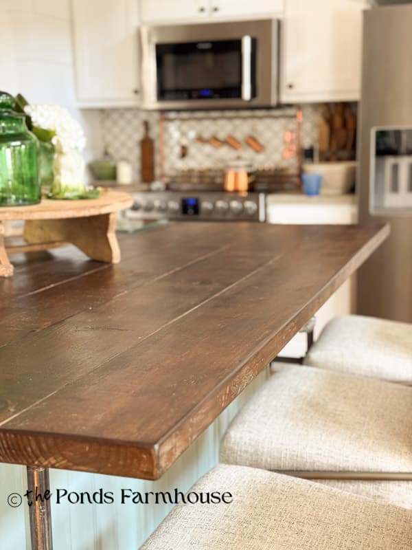 DIY kitchen island with natural wood top for an eat-in bar with bar stools