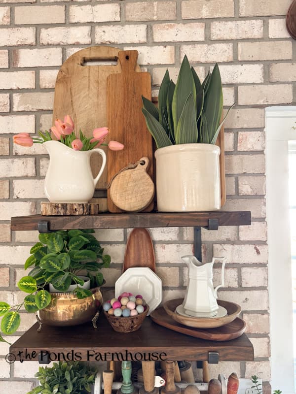 DIY Open Kitchen Shelves with wooden accents on brick wall