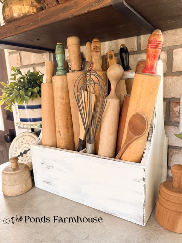 Old Toolbox filled with vintage rolling pines on kitchen countertop