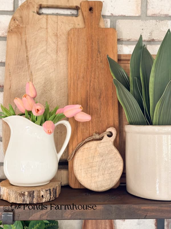 Open kitchen shelves with vintage cutting boards and ironstone