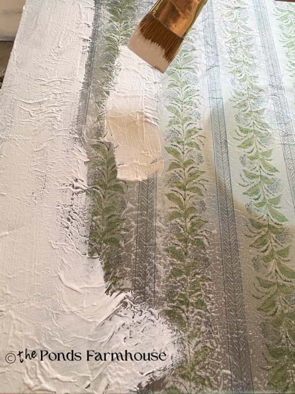 Painting backside of cutting board with reverse napkin decoupage.  