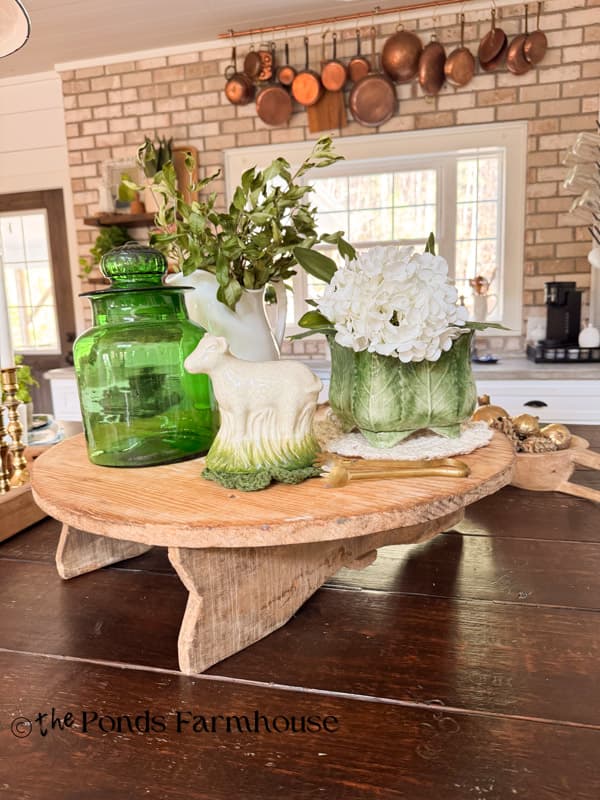 Vintage European Cheese Board with Green Accents on kitchen island with copper on kitchen wall