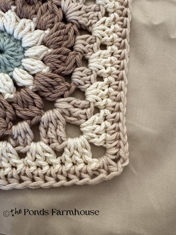 decorative edge to the granny square pillow cover