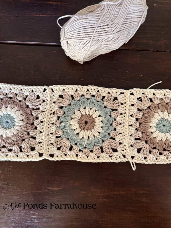 One row of pillow cover with granny square attached together.