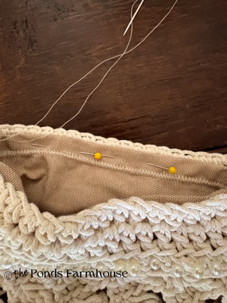 hand stitch the liner to the top of the handbag