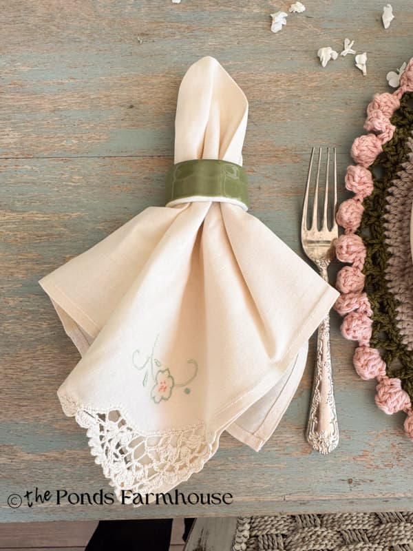 vintage embroidered napkins with crochet edge and thrifted green napkin rings