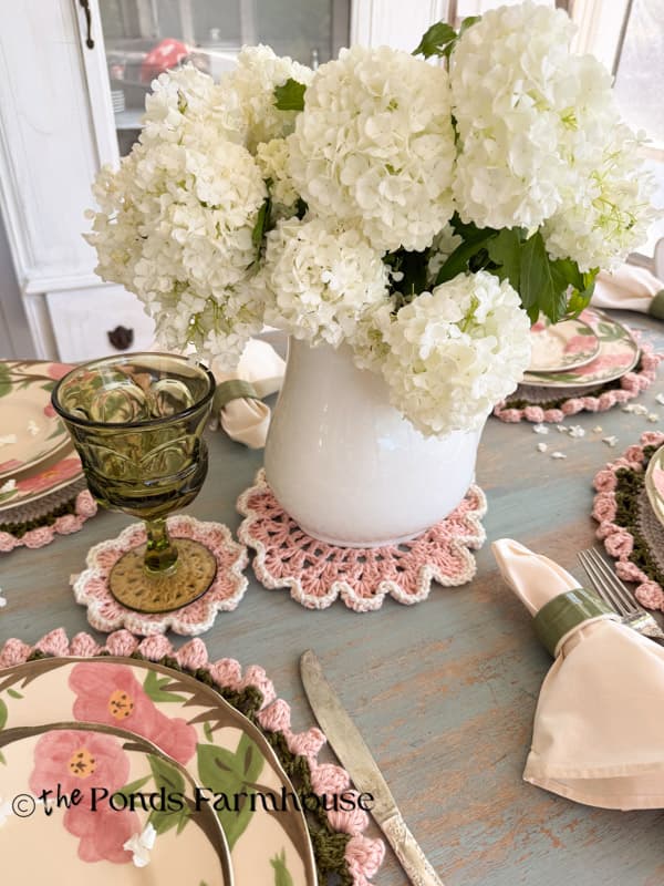 vintage ironstone pitcher on crochet doily with fresh snowball blooms for centerpiece