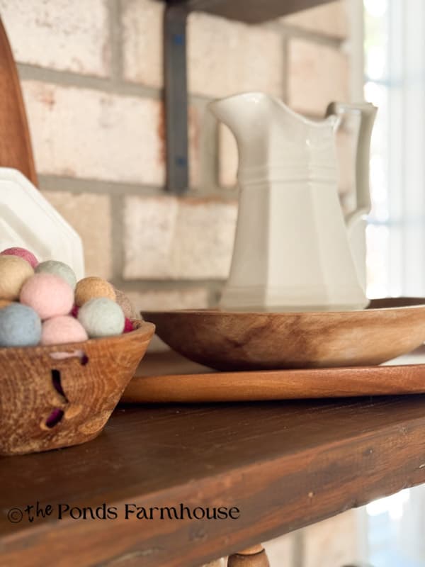 wooden bowls on open kitchen shelves