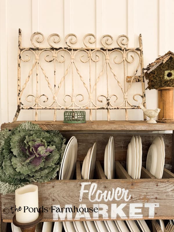 antique iron gate as art on screened porch.