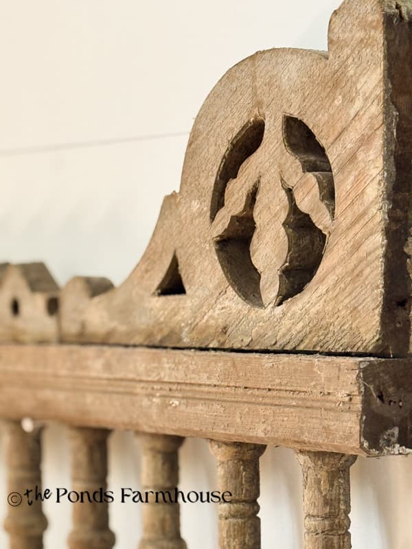 close up of antique porch fretwork salvaged and used over barn door