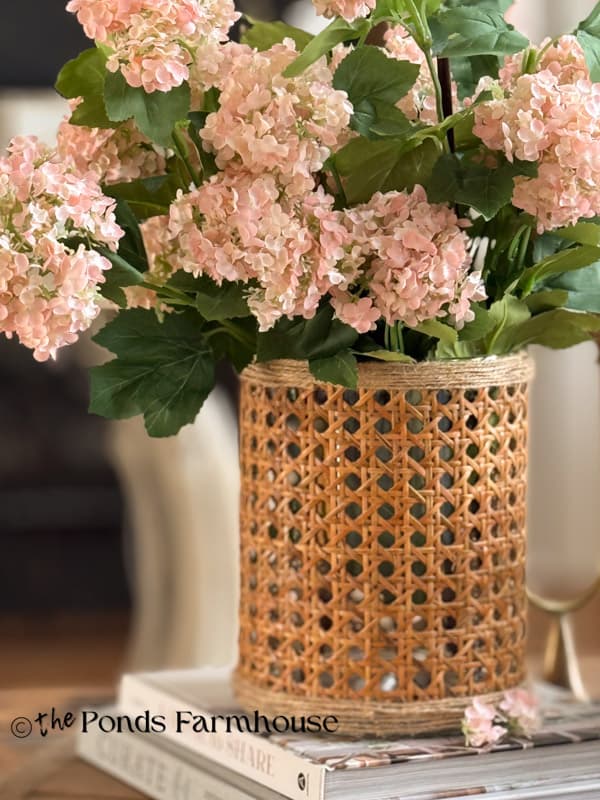 Close up of Serena & Lily Dupe Vase with pink snowball flowers on coffee table.