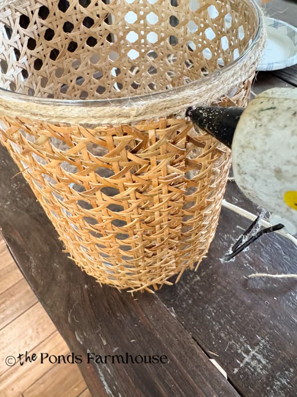 Use hot glue to hold jute twine in place at the top and bottom of the vases