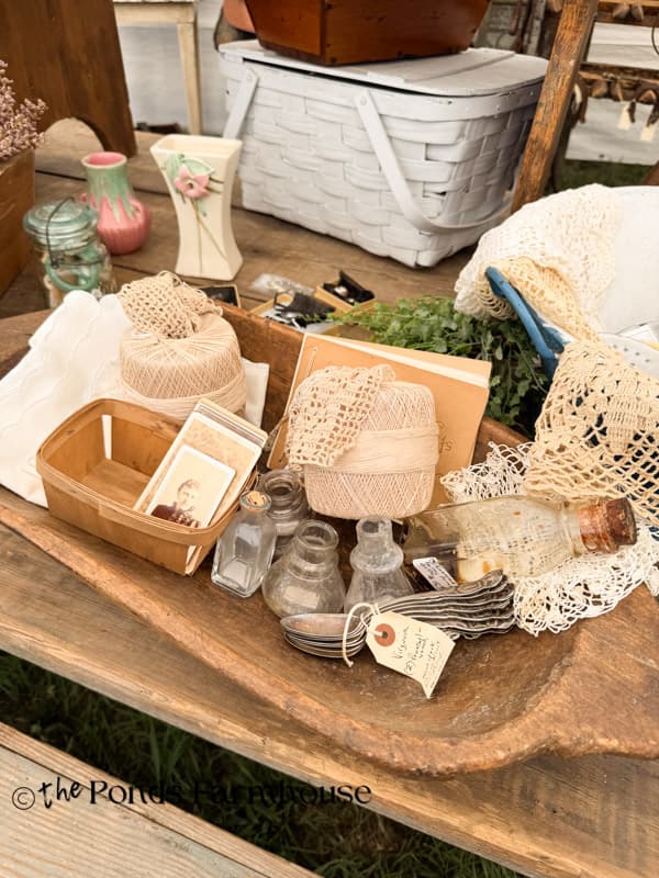 antique crochet and vintage bottle vignette in dough bowl at Liberty Antique show.