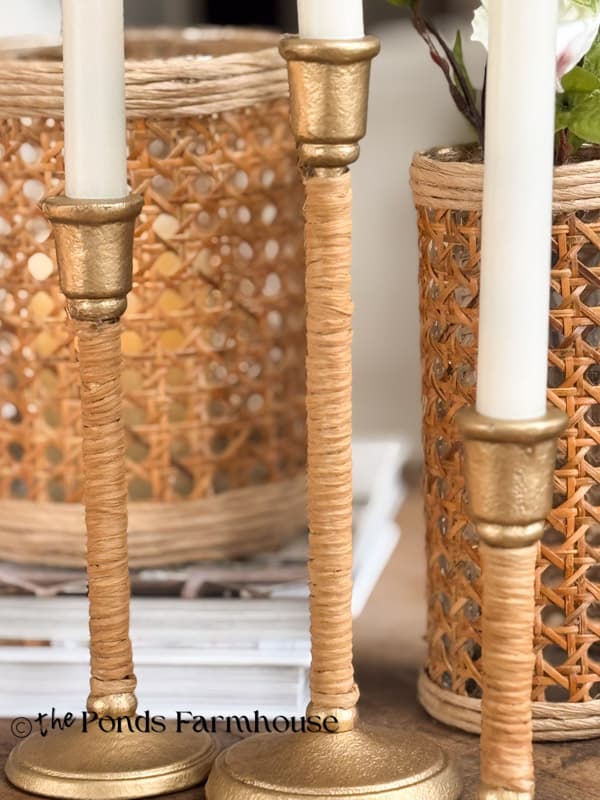 close up of three candlestick holders that look like Serena & Lily high end versions with DIY rattan vases
