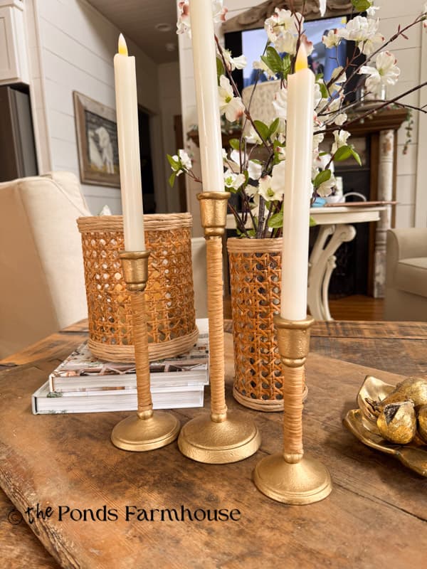 three candlestick holders that look like Serena & Lily high end versions with DIY rattan vases