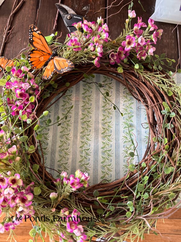 Add faux butterflies around the whole wreath