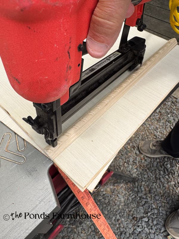 add rope trim to fake drawer fronts with nail gun
