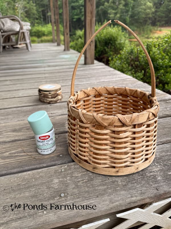 Damaged thrift store basket with broken handle and spray paint before upcycle.