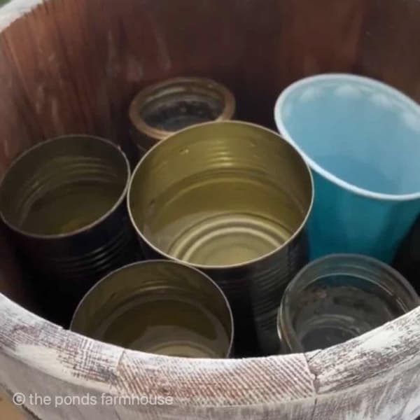 Fill Recycled Wooden Ice Cream Churn with tin cans to hold water for fresh flowers