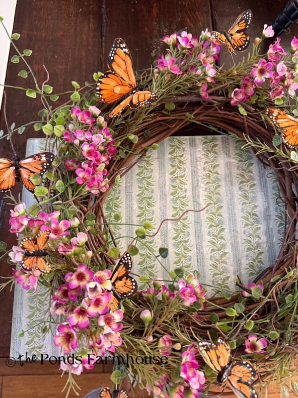 Add heavier flowers to one side of the summer wreath