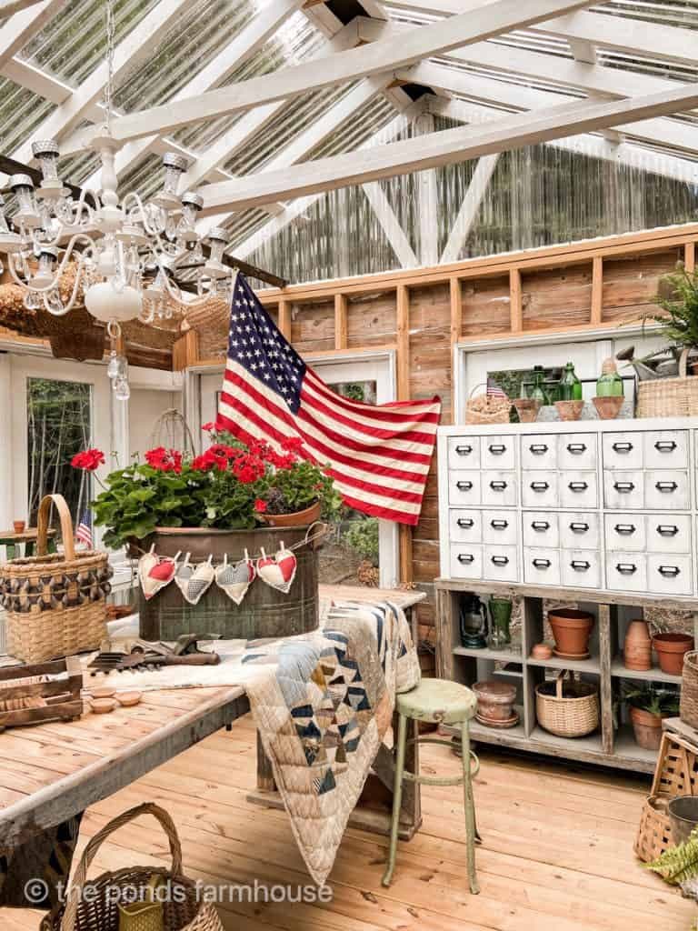patriotic greenhouse tour with brass boiler pot and red geranium centerpiece