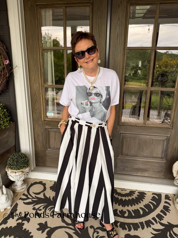 Rachel with graphic tee and black and white skirt