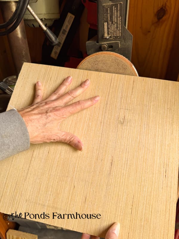 Bevel the edges of the fake drawers with a belt sander.  