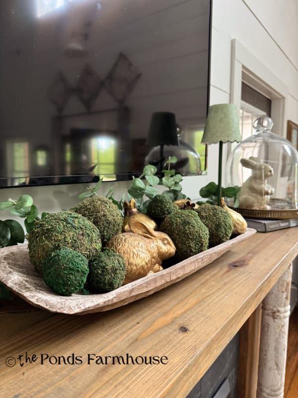 summer mantel with dough bowl full of moss balls and gold figs