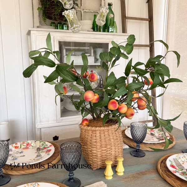 Summer table with peach stem & basket centerpiece 