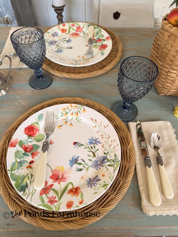 Summer table place setting with whimsical plates and silverware