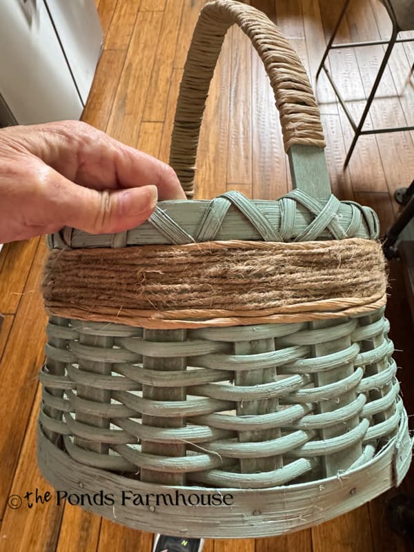 Upcycled basket with jute twine and vine wire applied under the top rim of basket