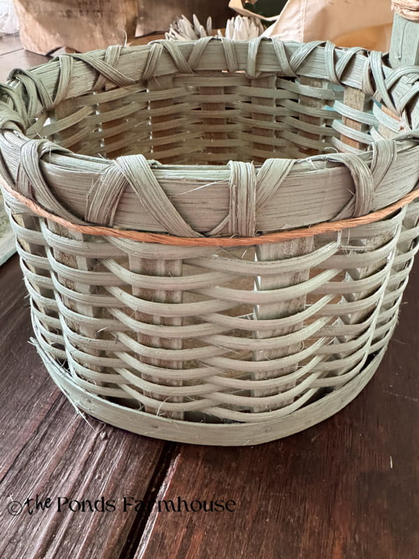 add vine wire around under the rim of the basket and secure with hot glue