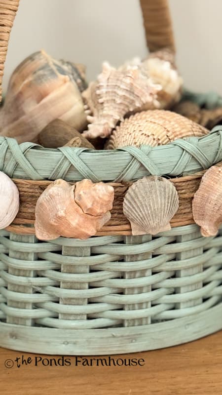 close up of DIY Upcycled Thrift Store Basket with added seashells and paint