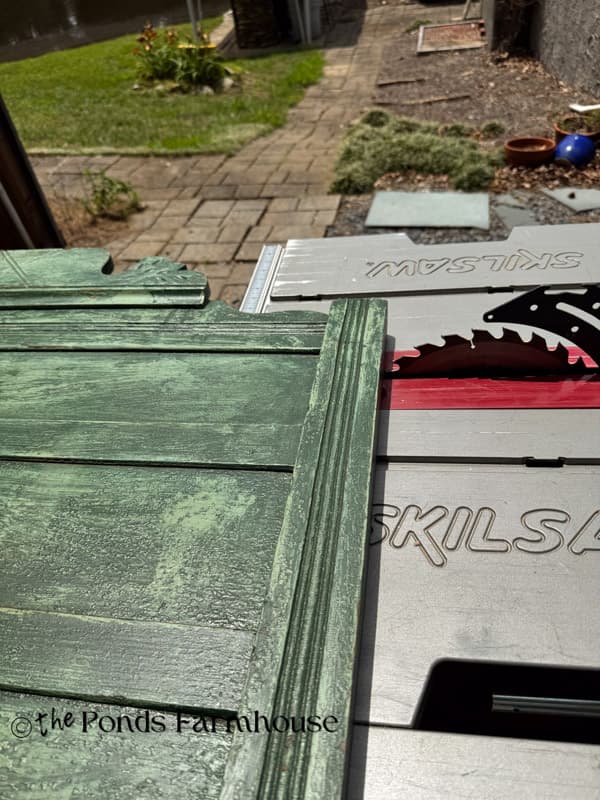 cut top of old headboard with table saw to make the armoire pediment