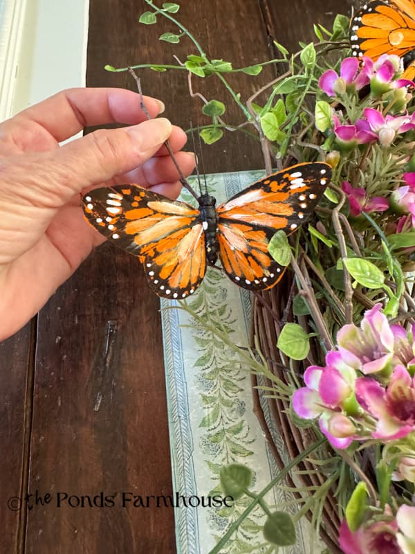 gathered twigs hold butterflies away from wreath